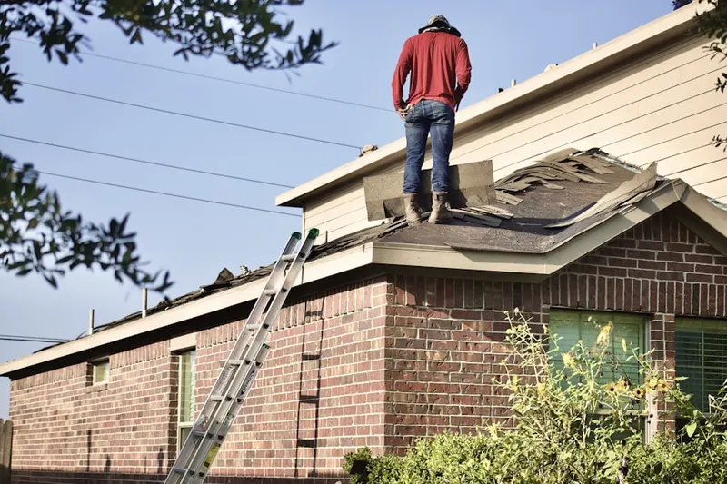 Professional roofer working on a residential roof in Husseys Crossroads